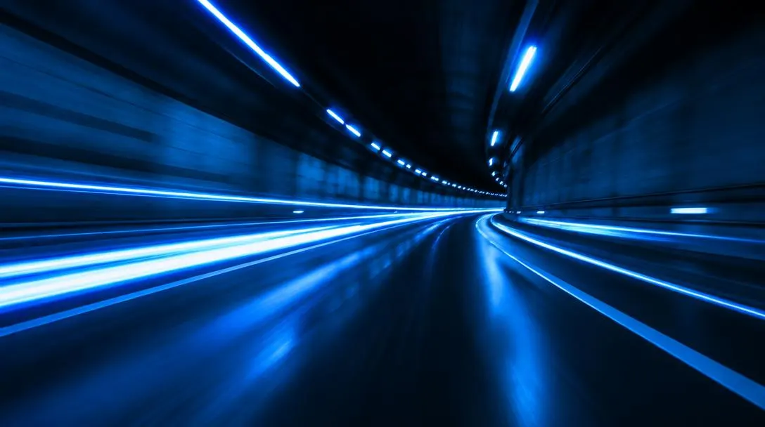 Blue light trails through a dark tunnel